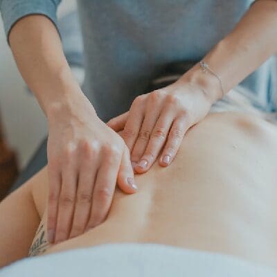 Massage therapist working on a patient's back