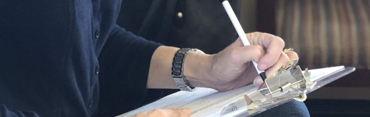 New patient filling out a form on a clipboard