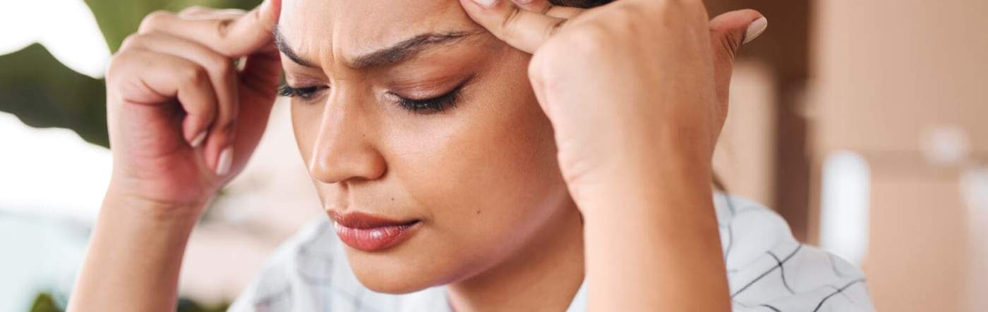 Person rubbing their temples during a tension headache